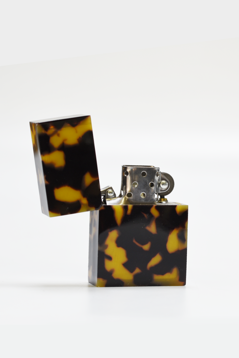 Tortoiseshell-patterned lighter on a white background