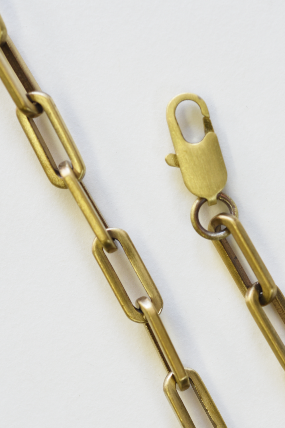 Gold chain with a clasp on a white background