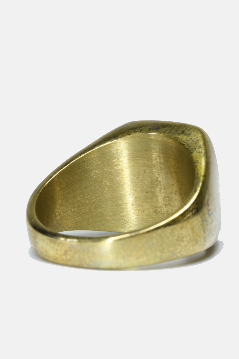A wide, chunky signet-style ring with a brushed brass or gold-toned finish, photographed on a clean white background.