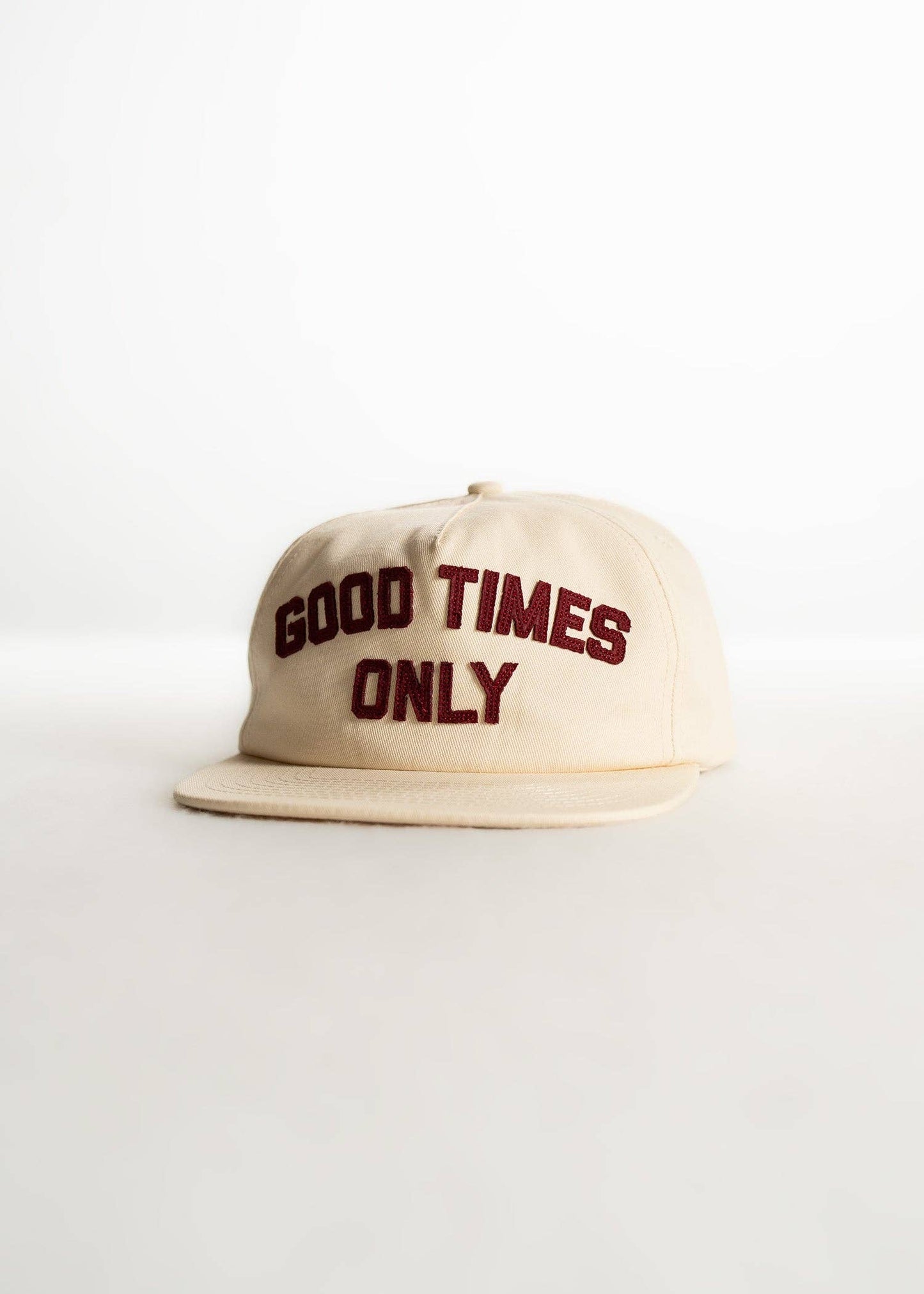 Beige cap with 'Good Times Only' text on a white background