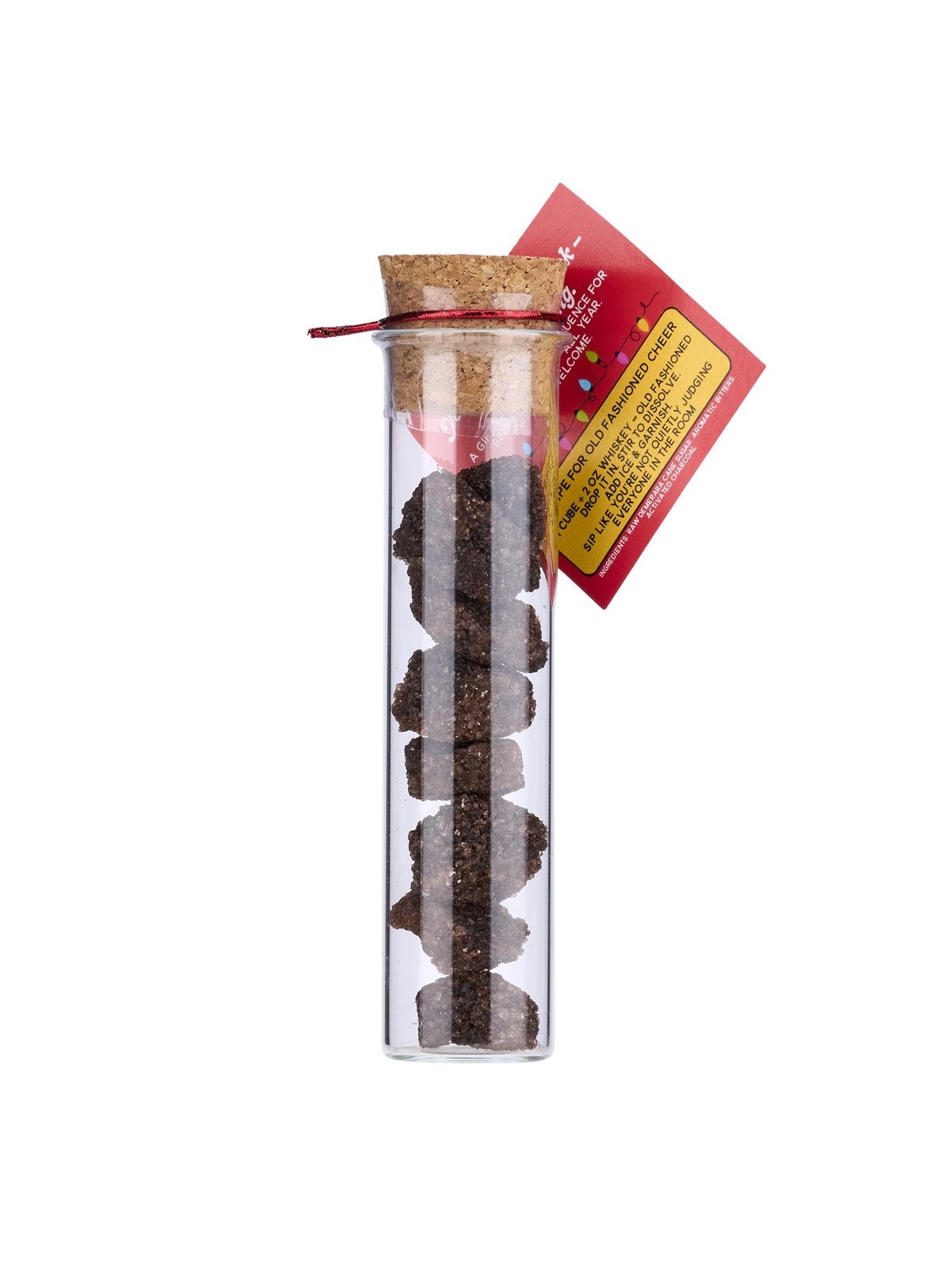 Clear glass tube with cork lid containing black tea leaves, red tag with text on a white background