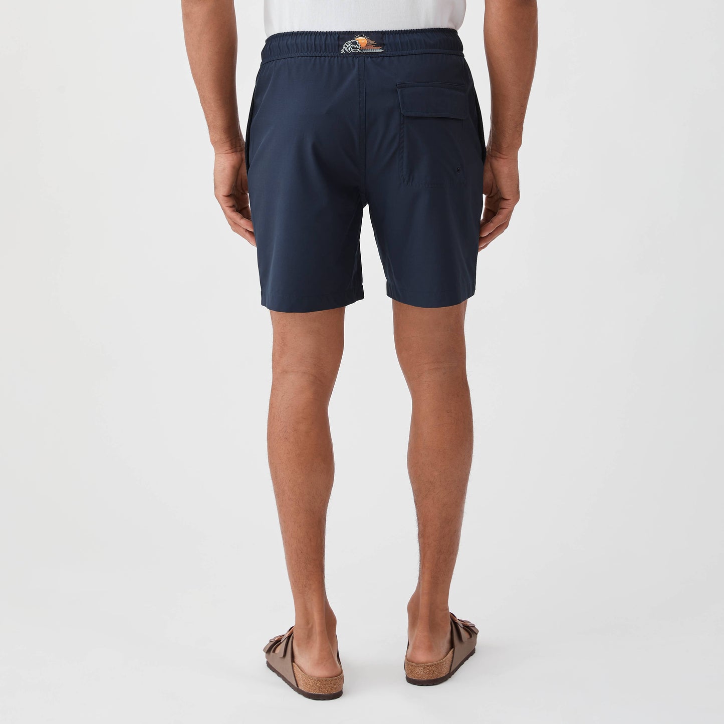 Person wearing navy shorts on a white background