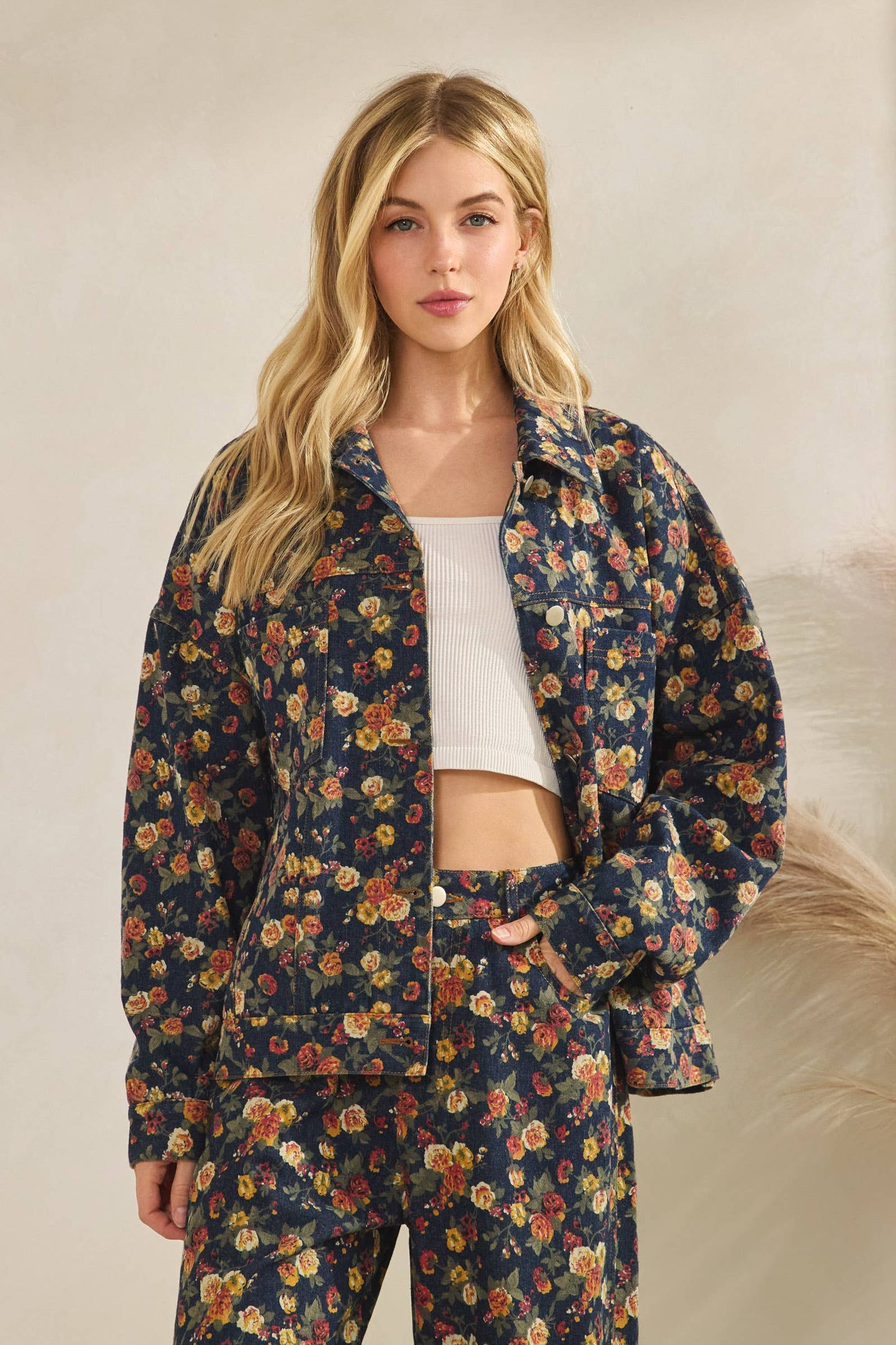 Woman wearing a floral outfit against a neutral background