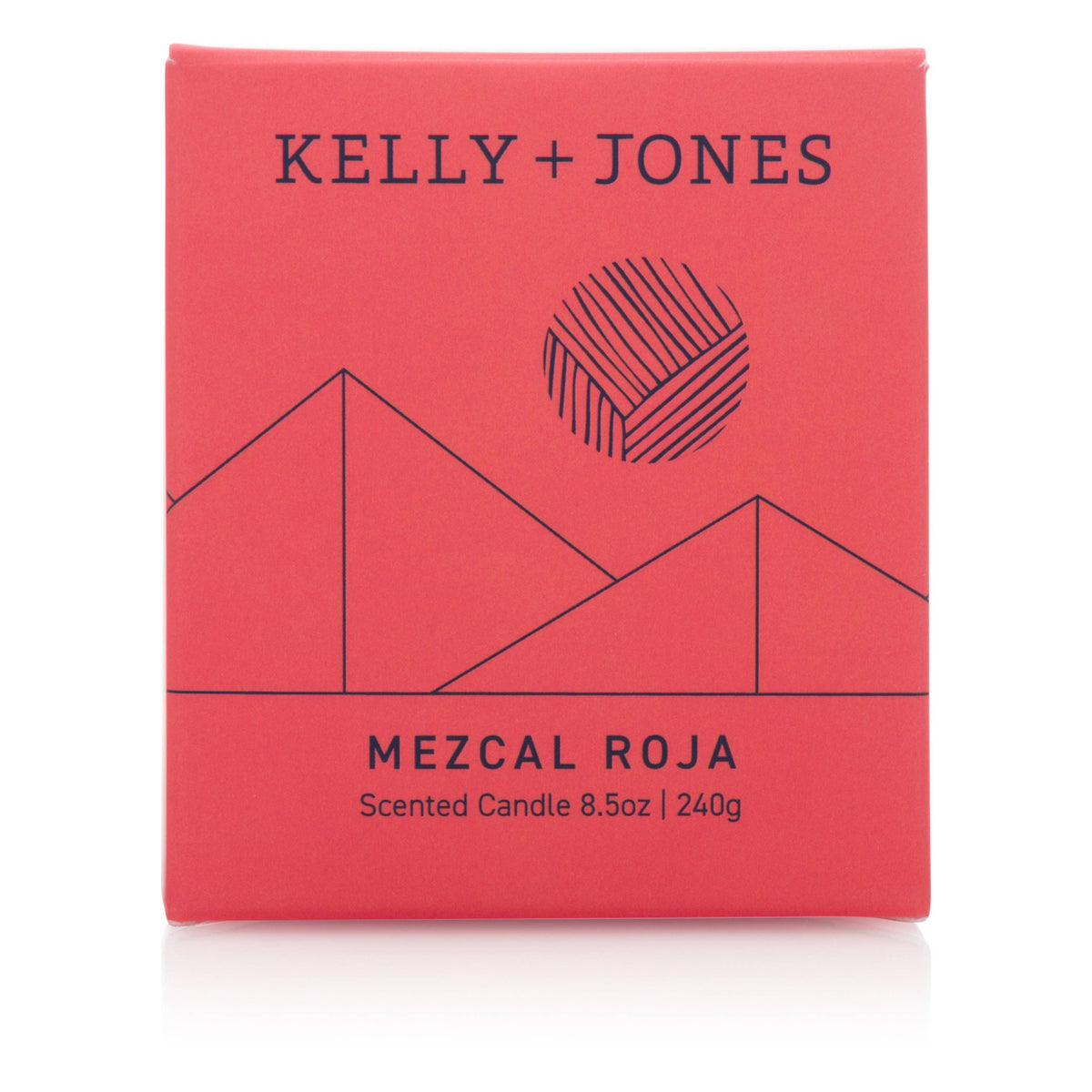 Red packaging of a scented candle by Kelly + Jones with geometric design