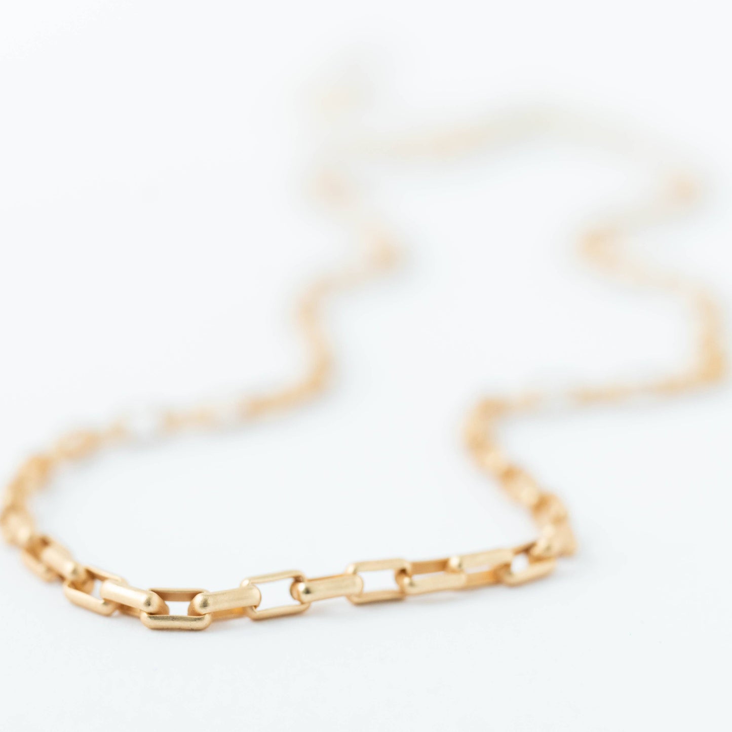 Gold chain bracelet on a white background
