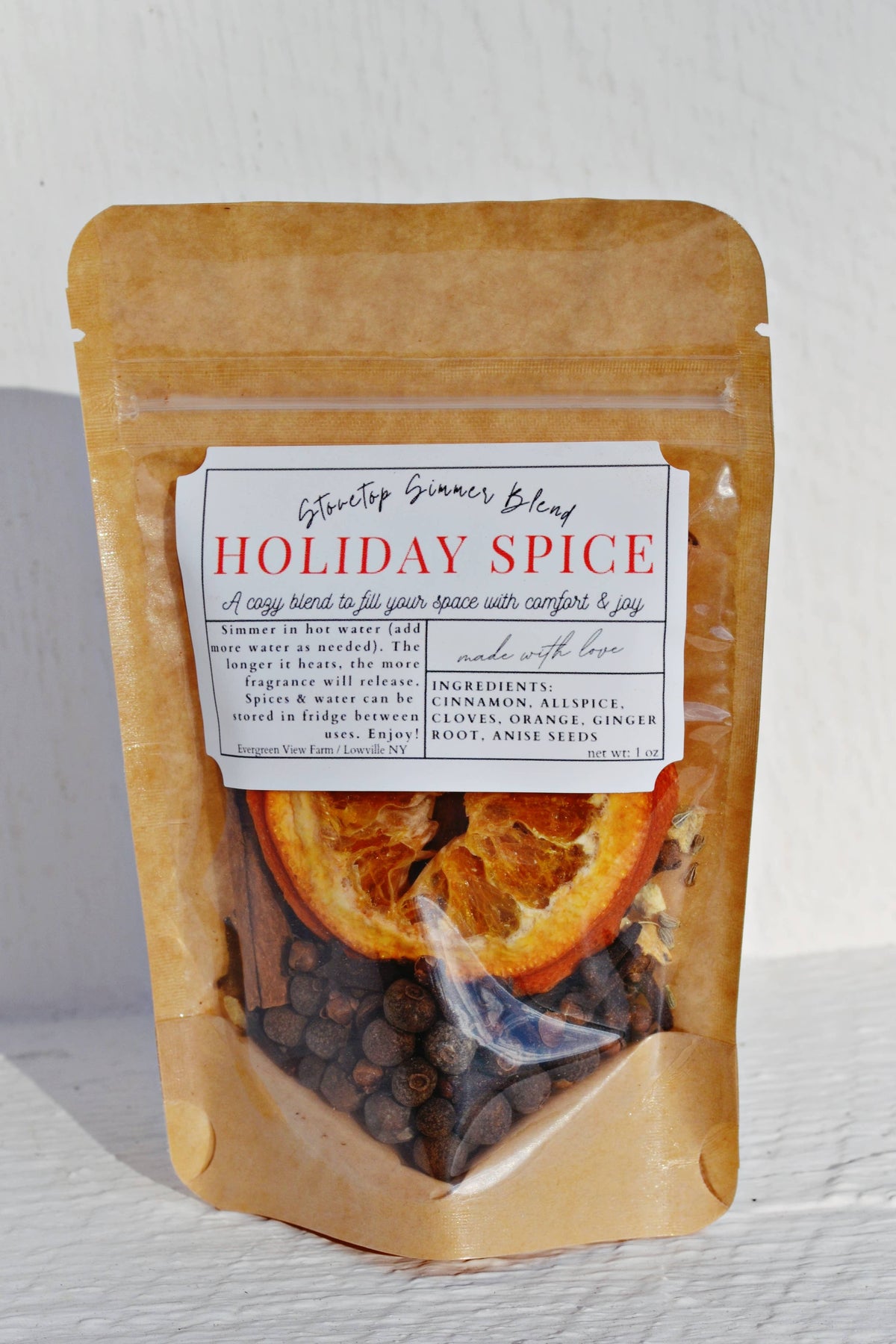 Packaged holiday spice blend with visible ingredients on a white background