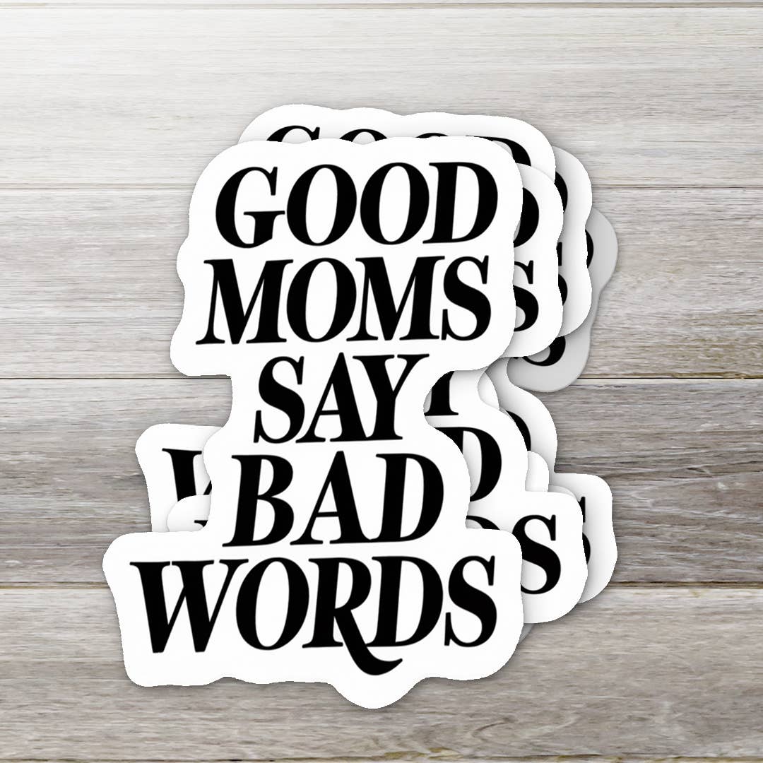 Stack of 'Good Moms Say Bad Words' stickers on a wooden surface