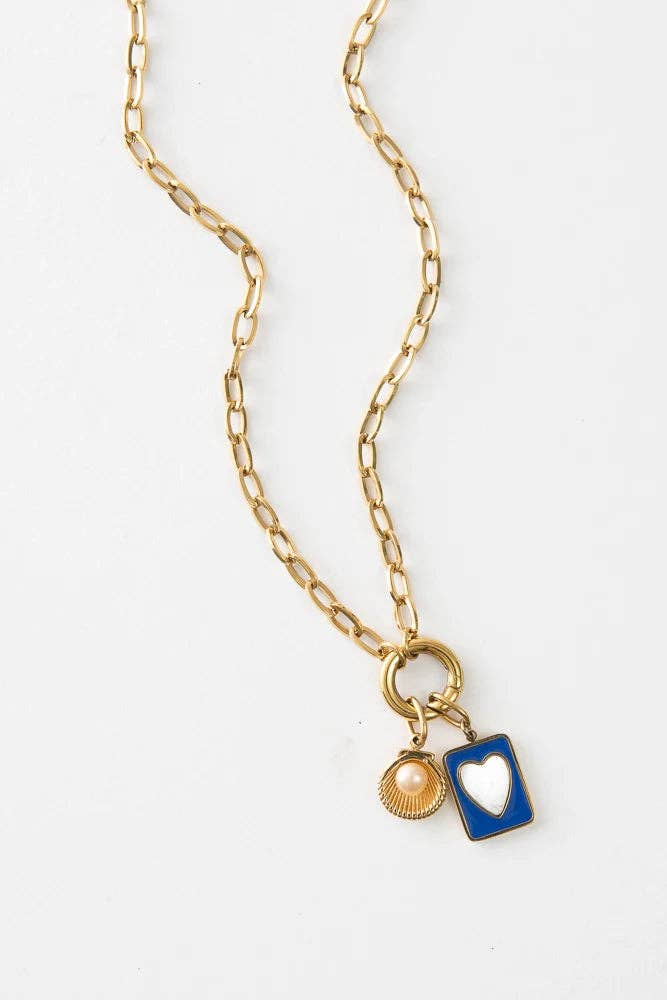 Gold chain necklace with a blue heart pendant on a white background