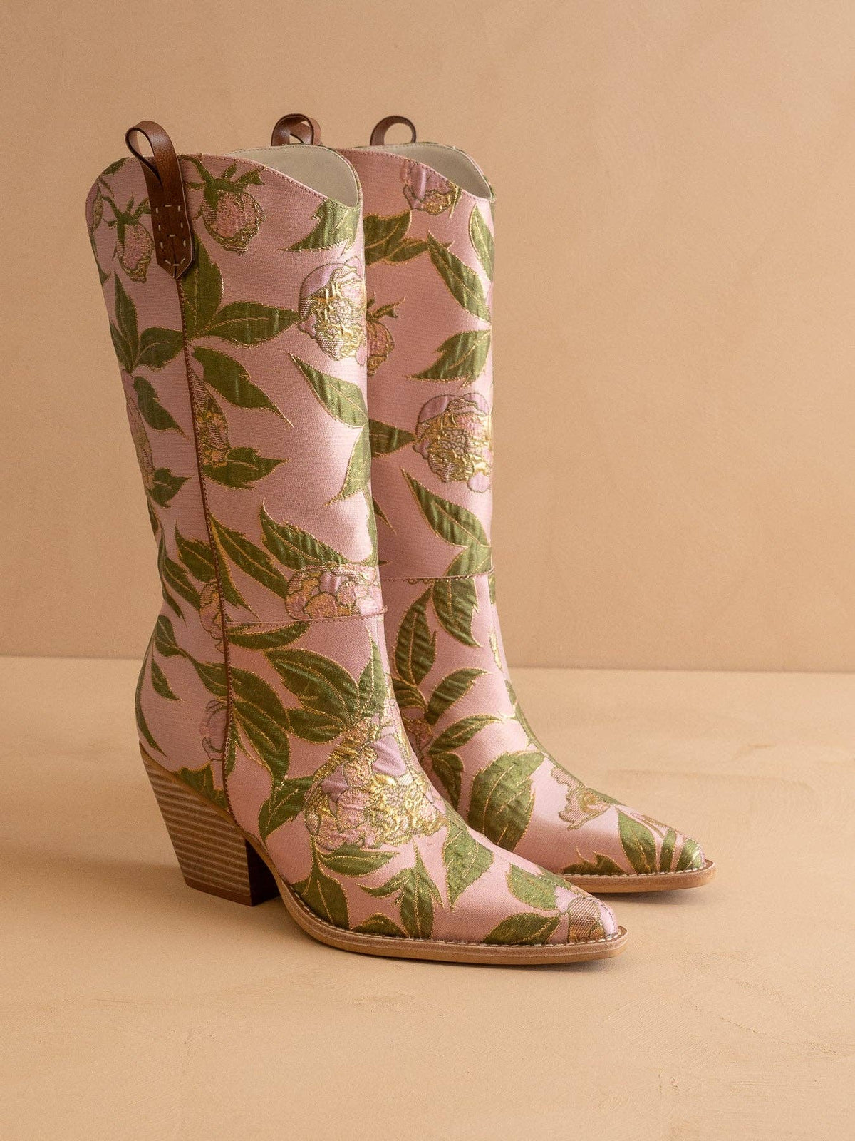Pink floral-patterned boots on a beige background