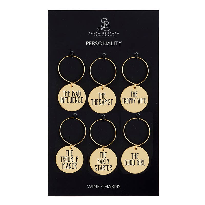 Set of six gold wine charms with humorous phrases on a black card, branded 'Santa Barbara Design Studio'.