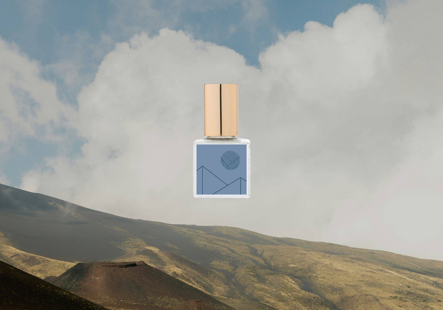 Perfume bottle with a mountain and cloud background