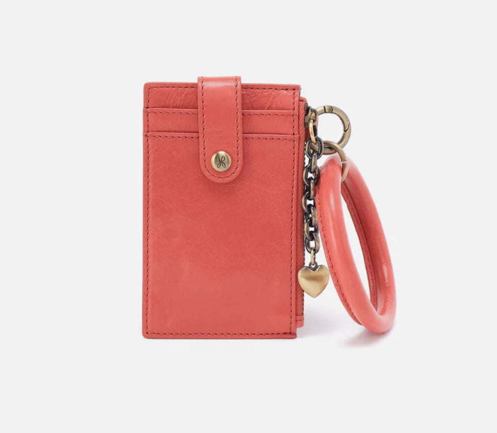 Pink wallet with a keychain on a white background