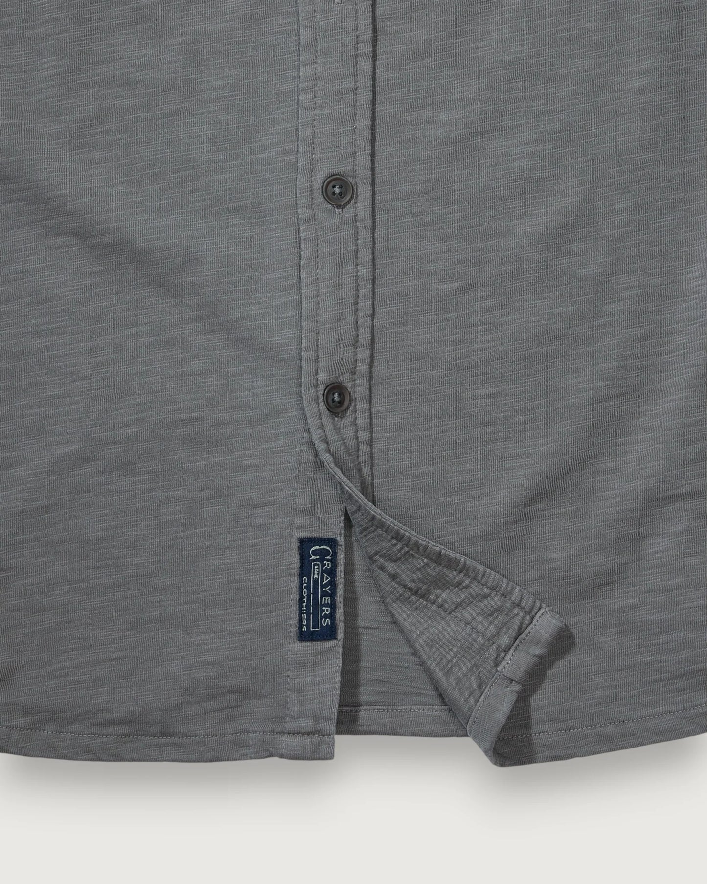 Gray shirt with a brand label on a white background