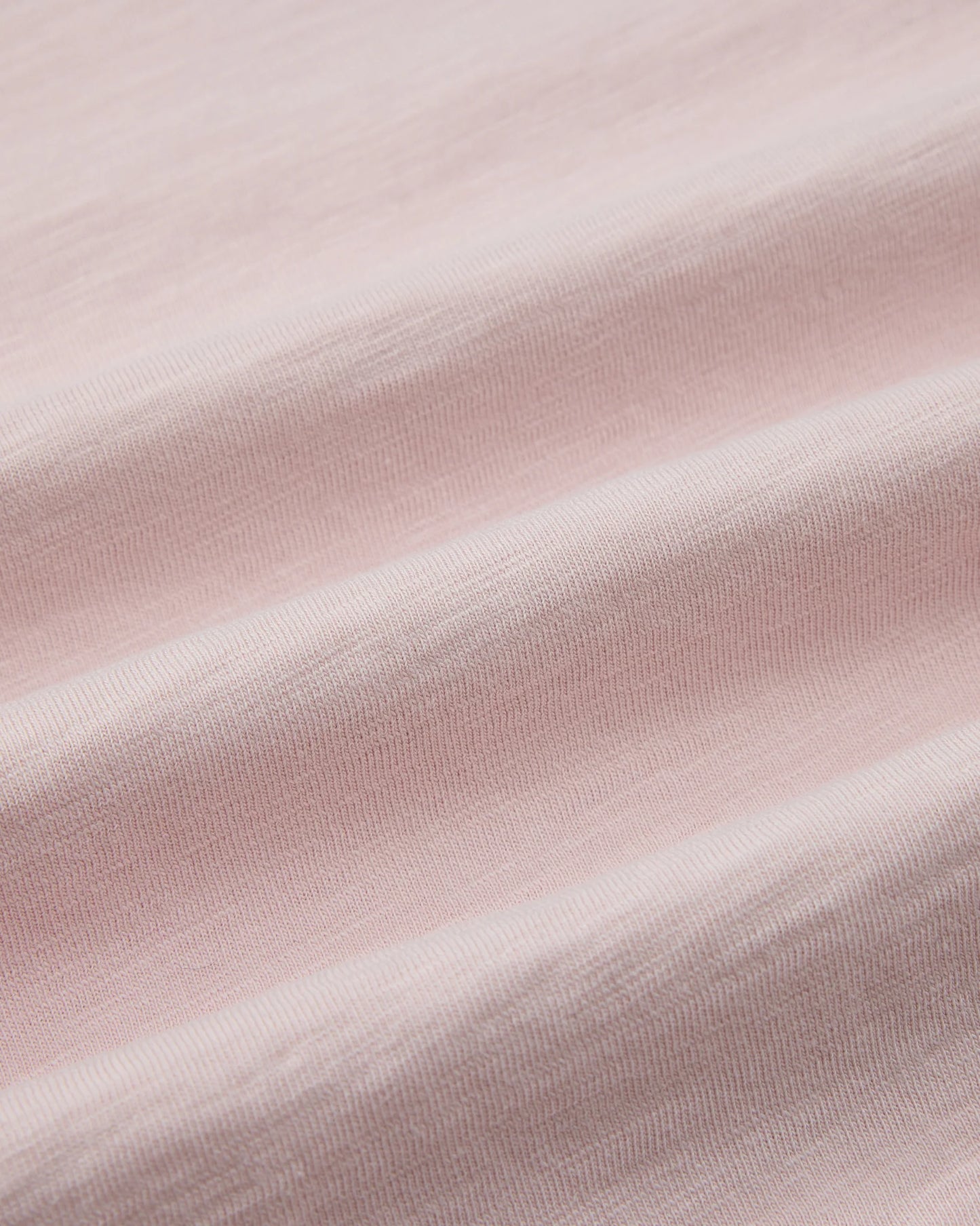 Close-up of light pink fabric texture
