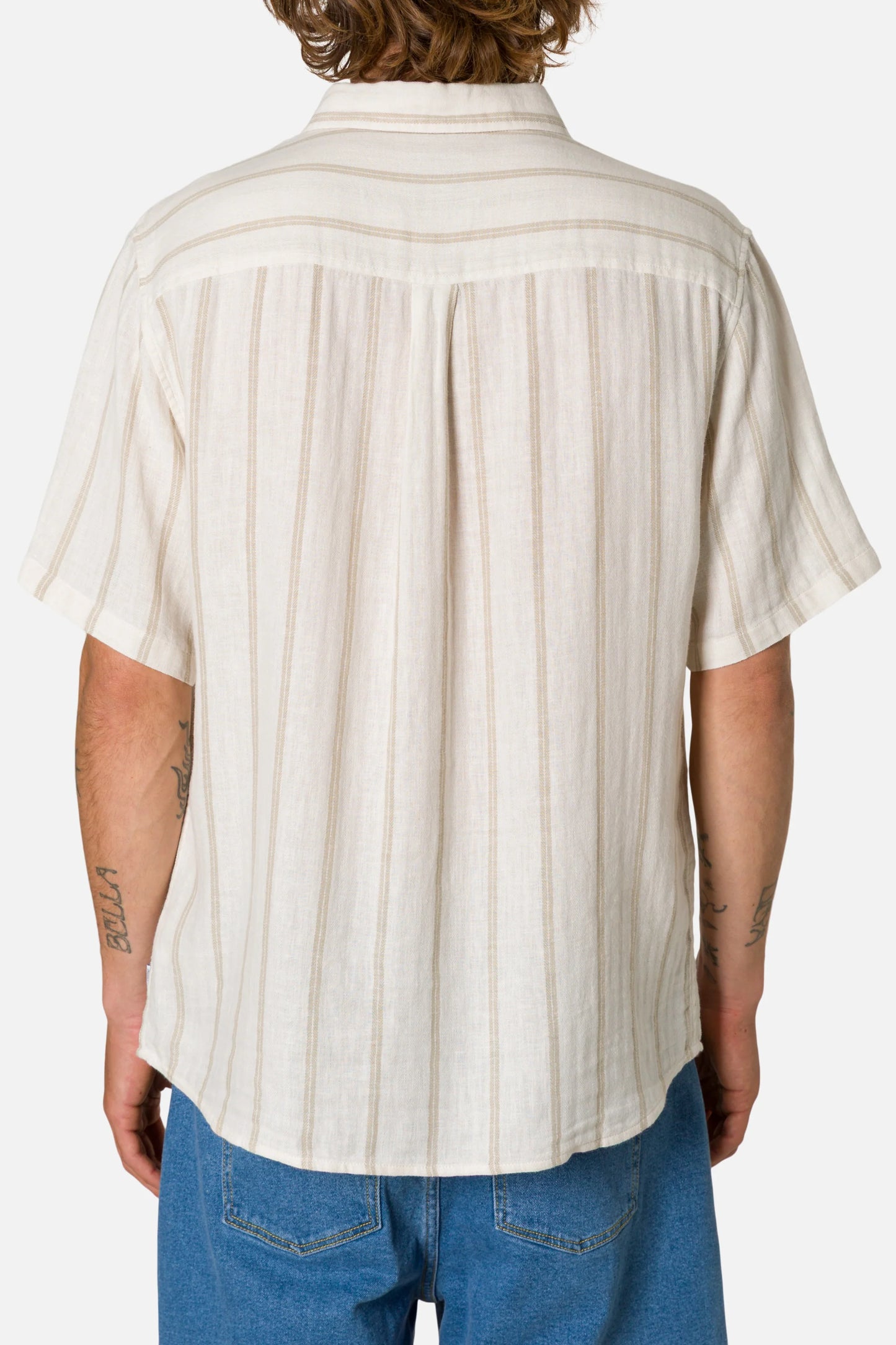 Person wearing a white striped shirt and blue jeans on a white background