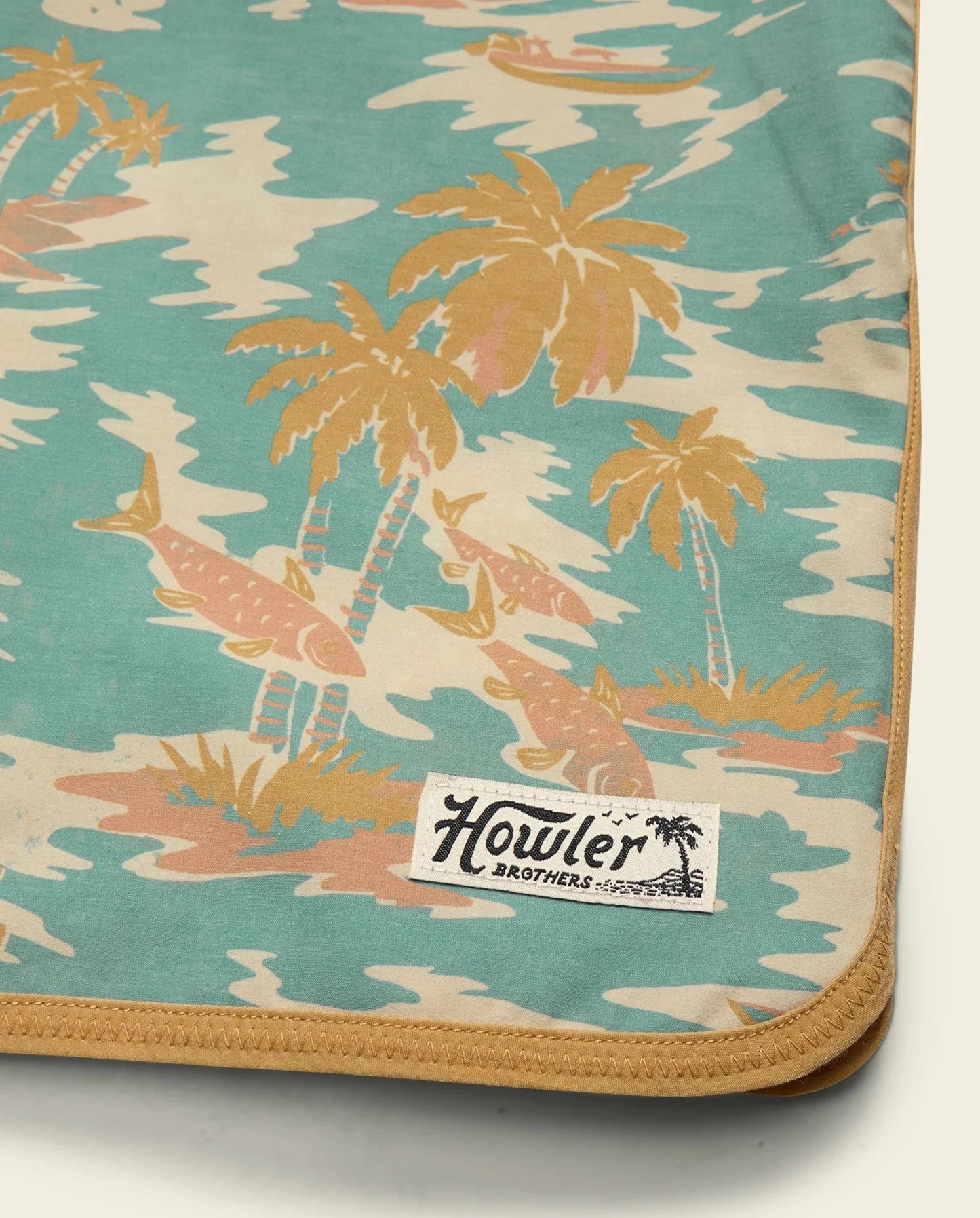 Palm tree patterned fabric with Howler Brothers label on a white background