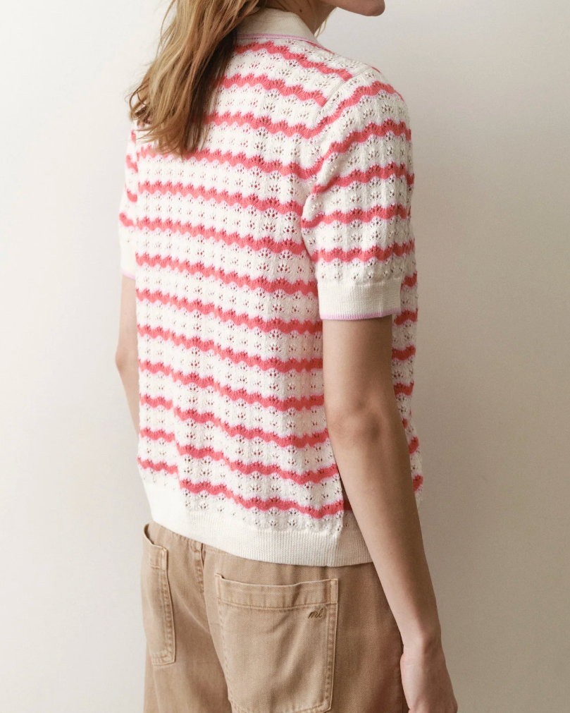 Person wearing a red and white striped shirt against a plain background