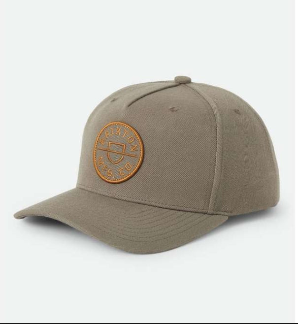 Beige cap with a brown leather patch on a white background