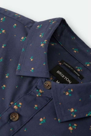 Navy shirt with floral pattern and Brixton label on a white background