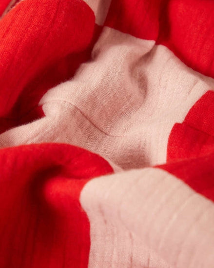 Close-up of red and beige fabric with a visible seam