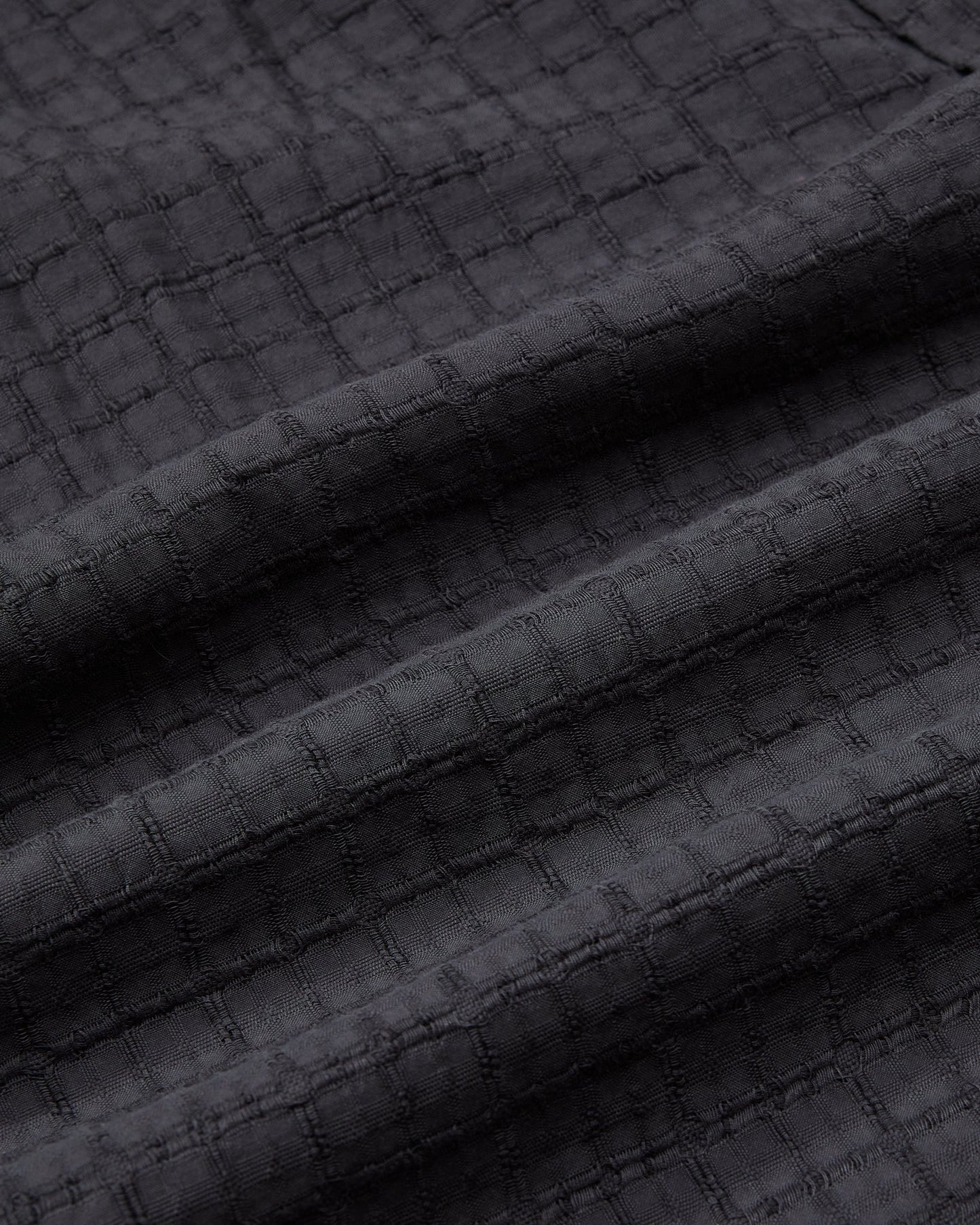 Dark textured fabric with a subtle pattern
