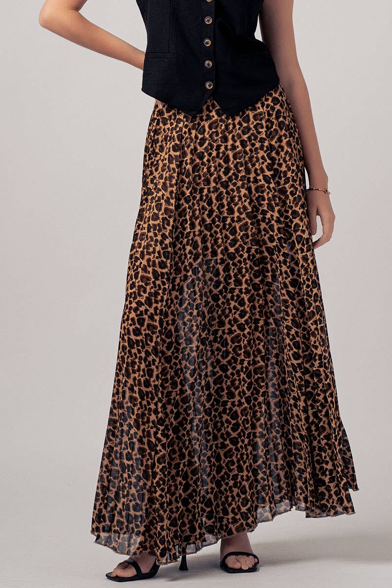 Person wearing a leopard print skirt and black top on a plain background