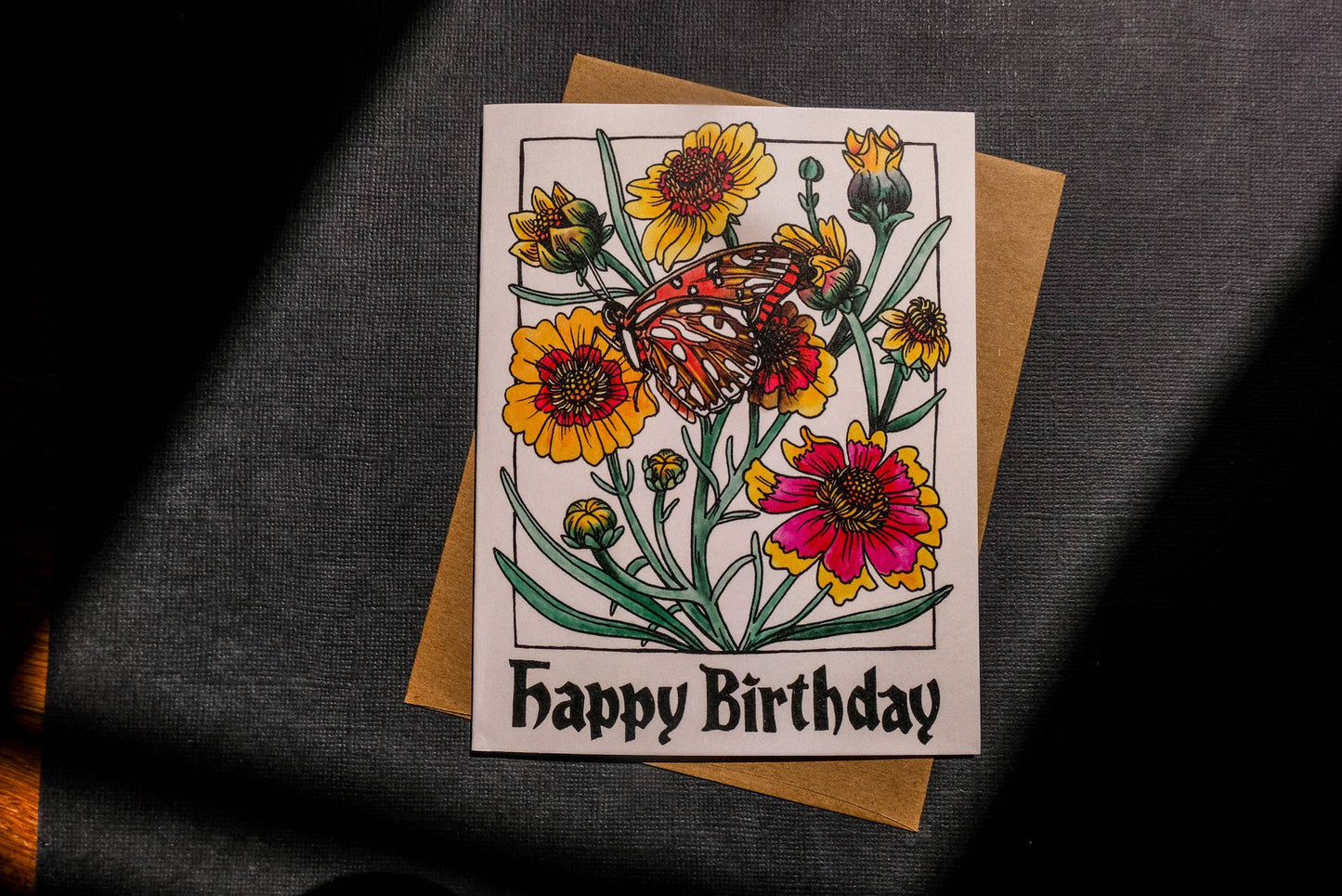 birthday card with butterfly and flowers against charcoal background
