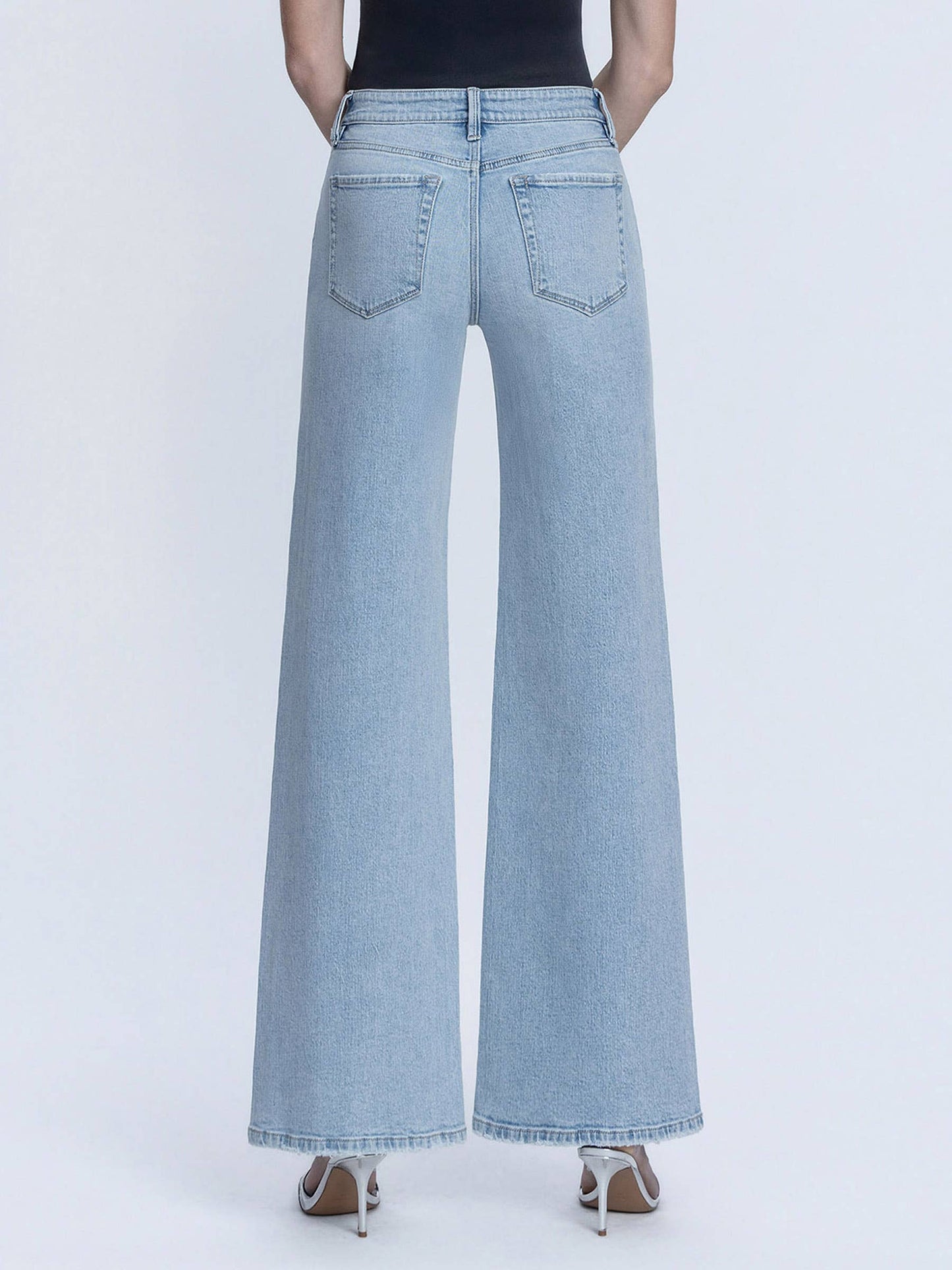 Light blue wide-leg jeans worn by a person on a white background