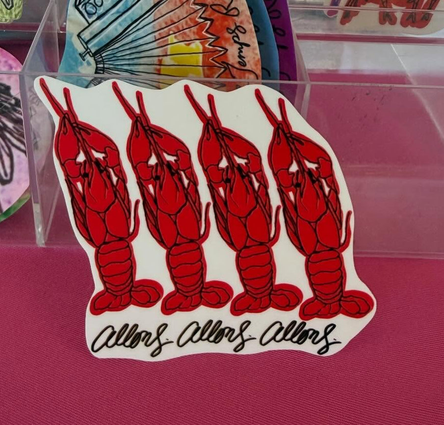 Crawfish stickers with the french words allons which means lets go.