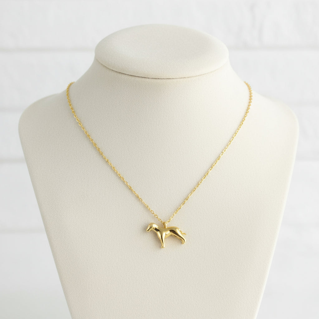 Gold necklace with a dog pendant on a beige card with 'Wearclue' branding.