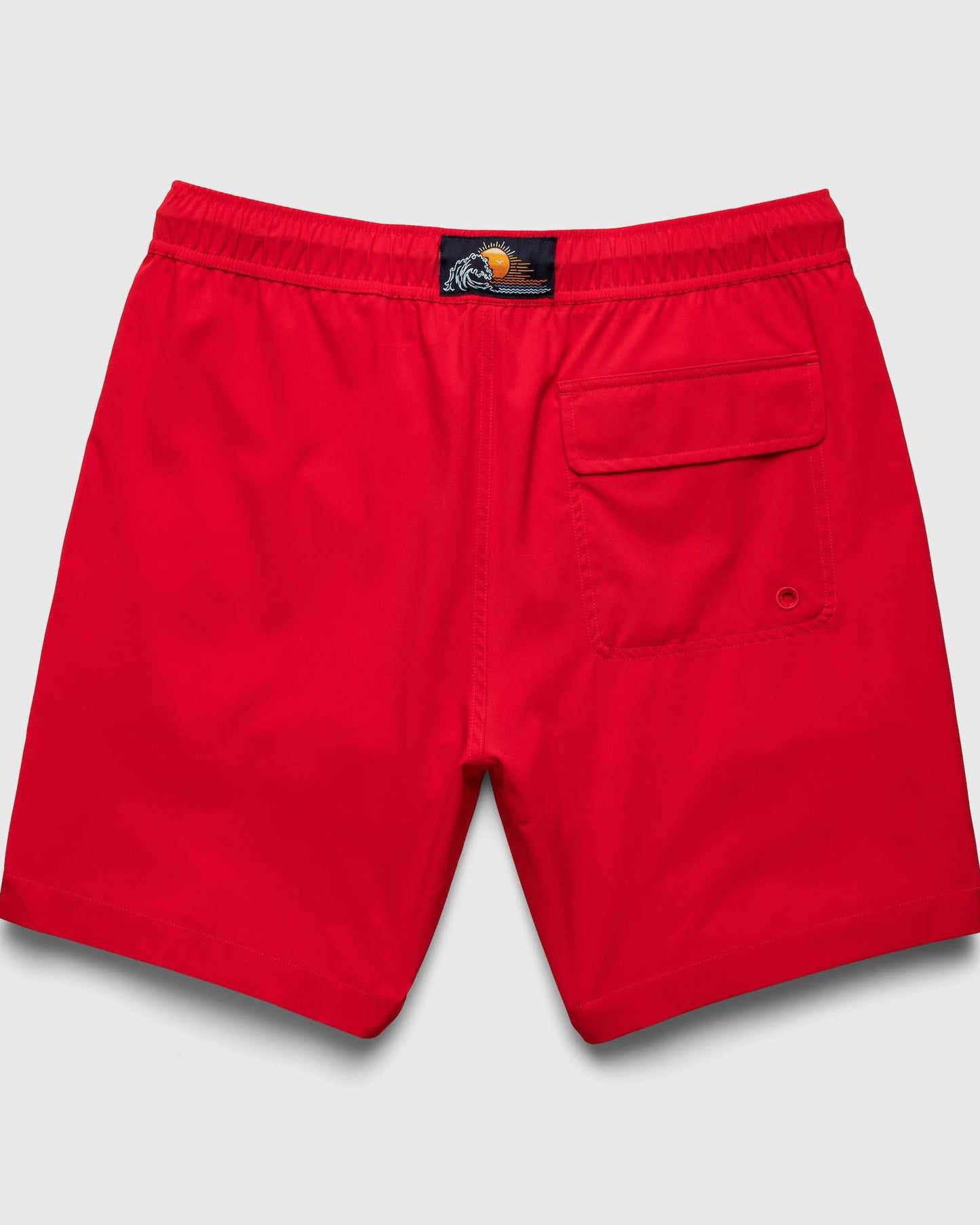 Red shorts with a brand label on a light gray background