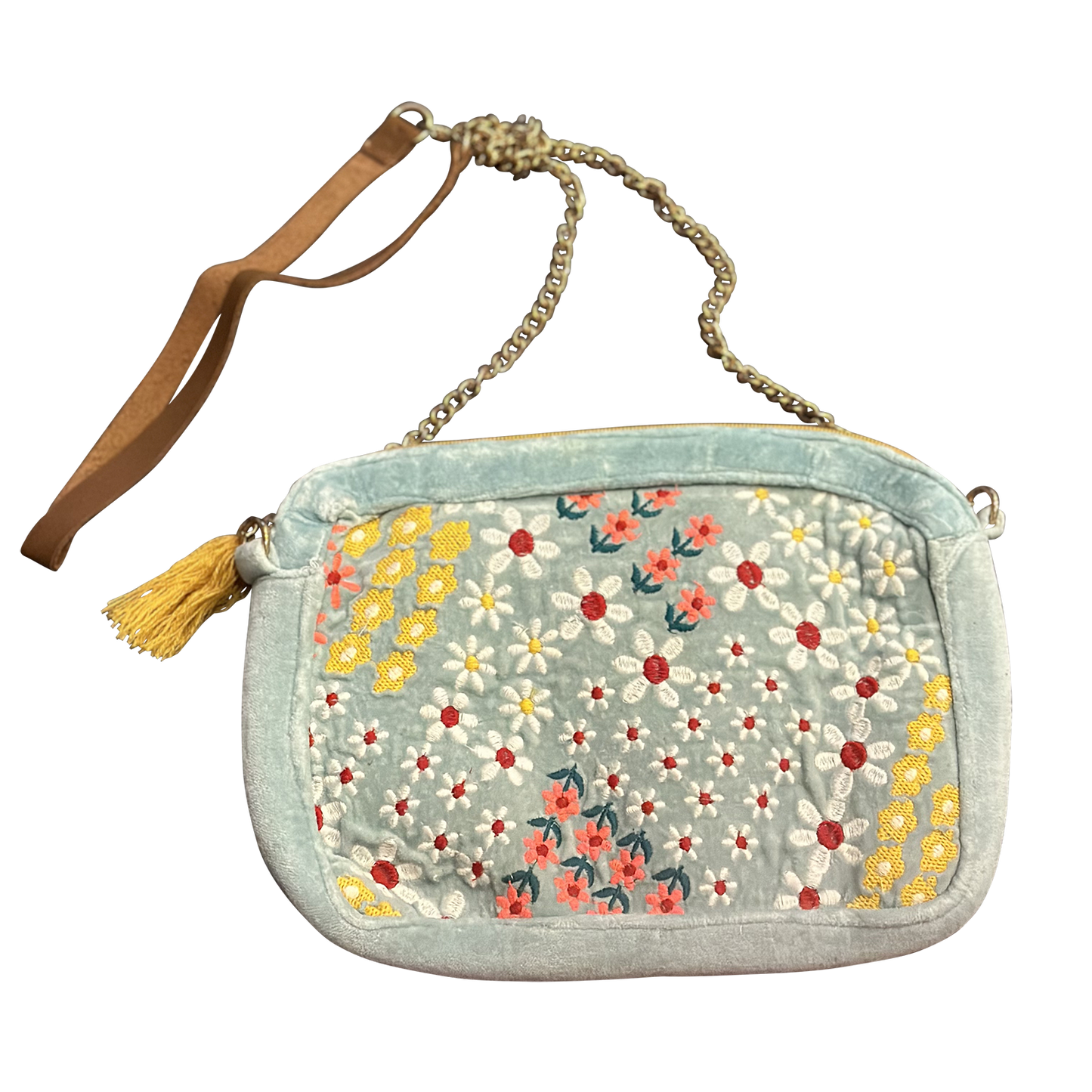 Floral patterned handbag with a tassel on a white background