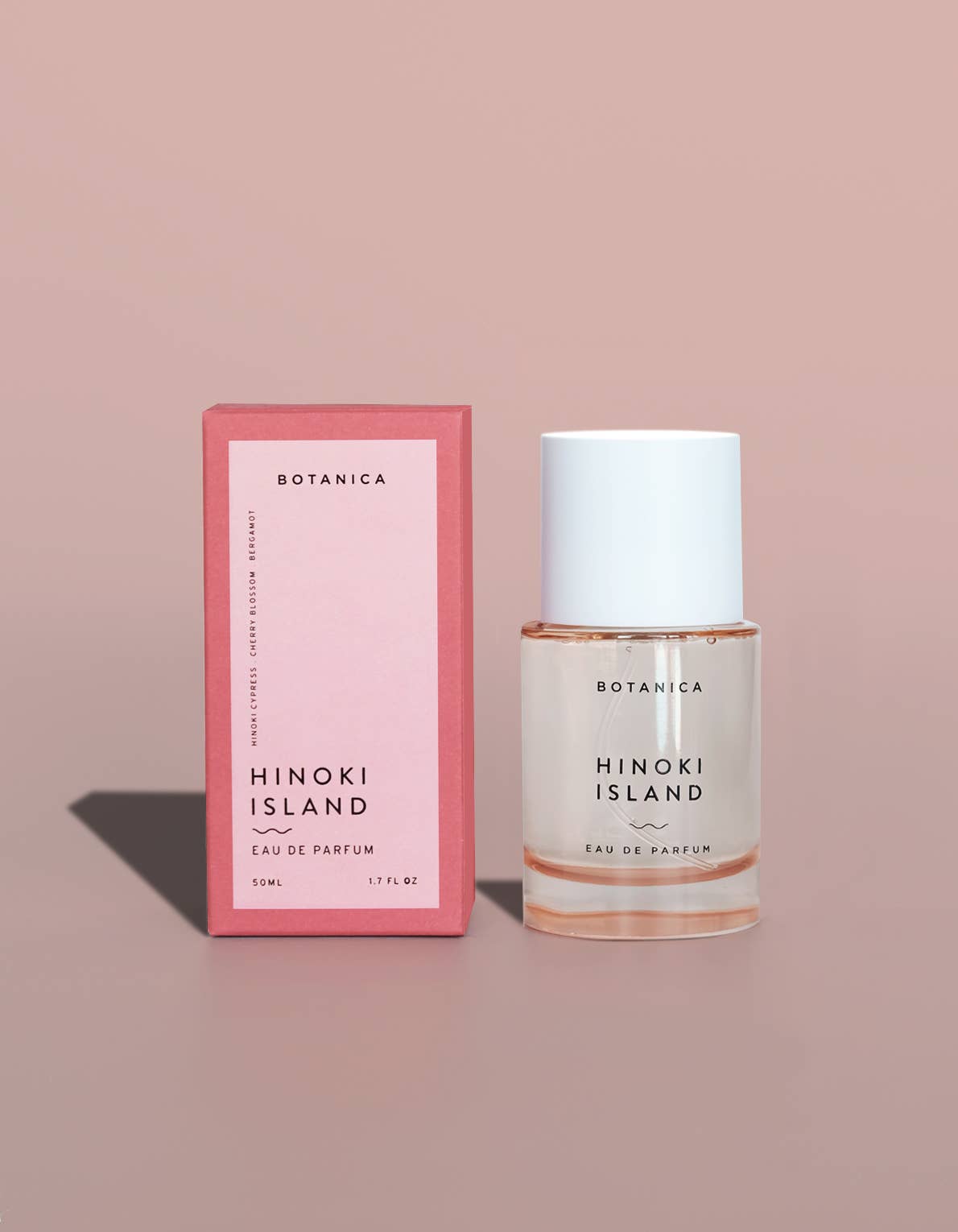 Botanica Hinoki Island eau de parfum bottle and packaging on a beige background
