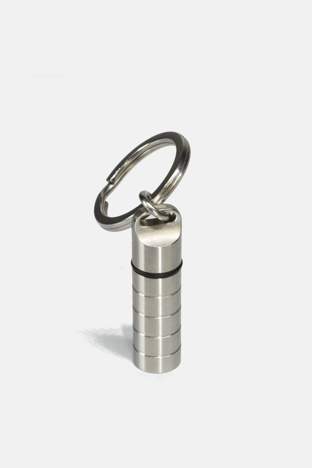 Metallic cylindrical keychain with a carabiner on a white background