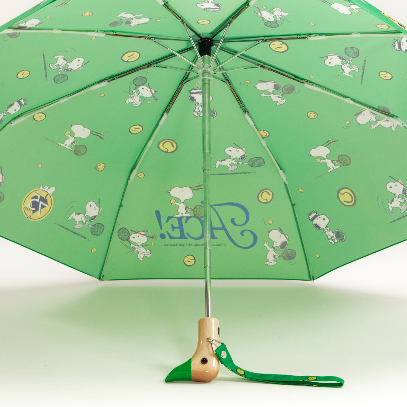 Green umbrella with cartoon character design on a white background