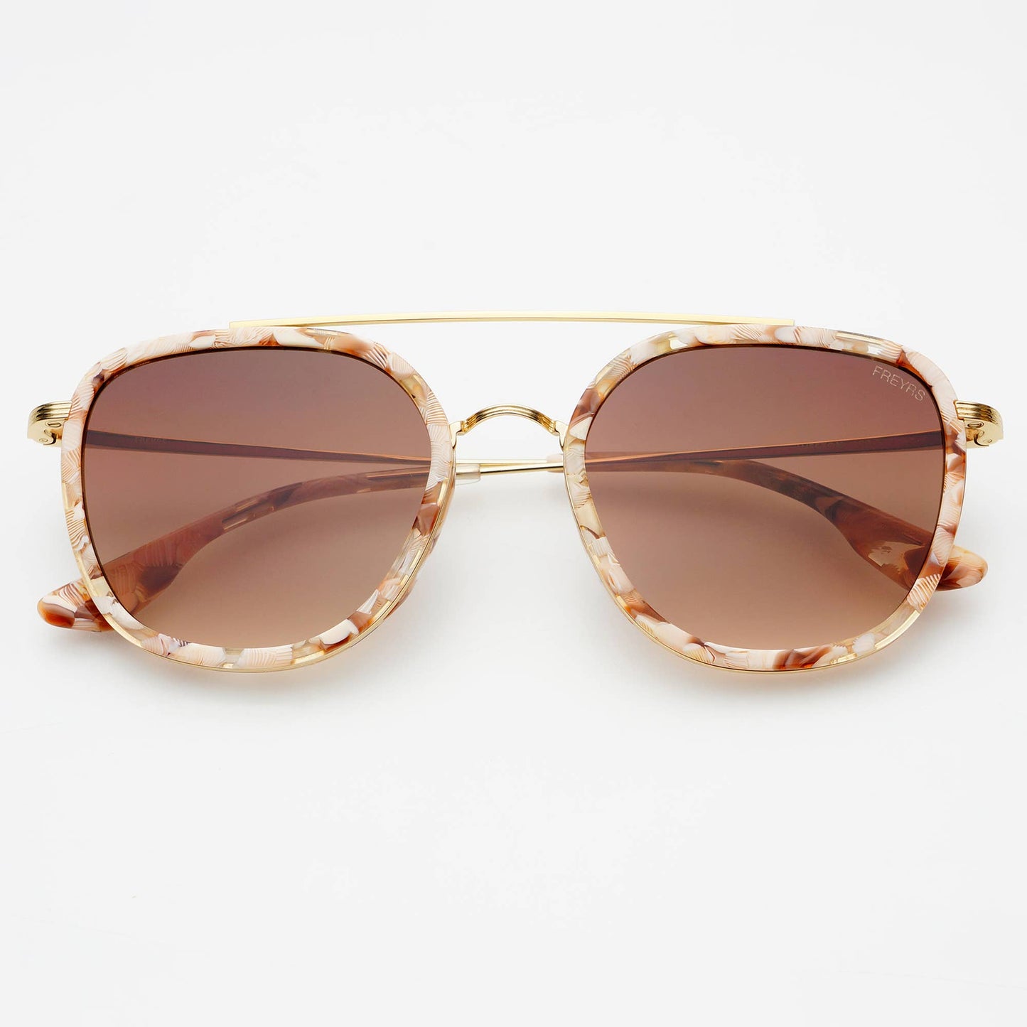 Sunglasses with gold frame and tortoiseshell accents on a white background