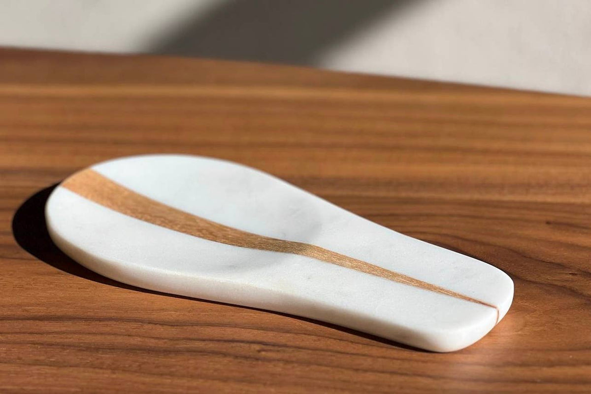 Marble stone with gold stripes on a wooden surface
