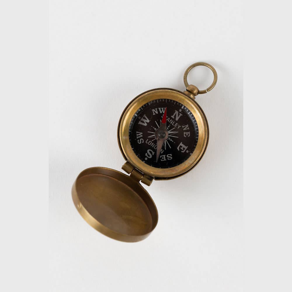 Brass compass on a white background