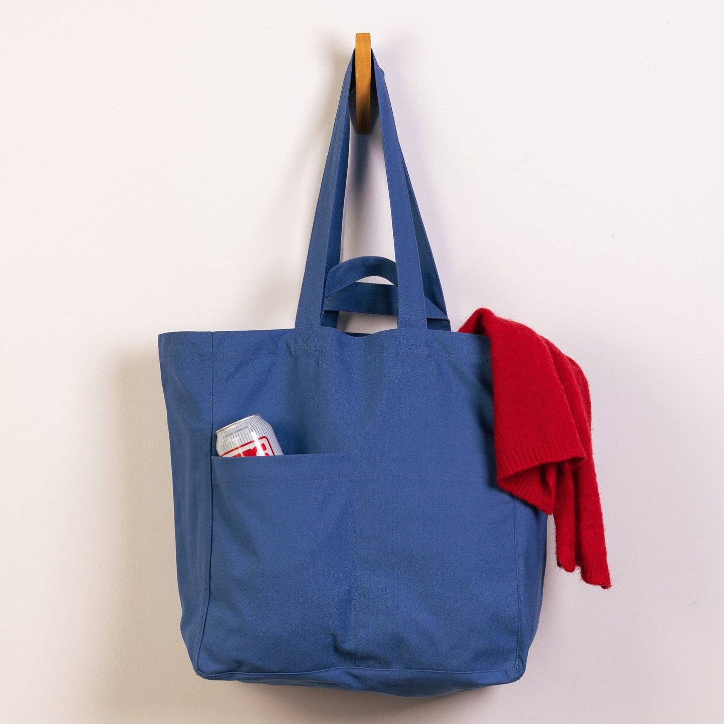 Blue tote bag with a pocket on a white background