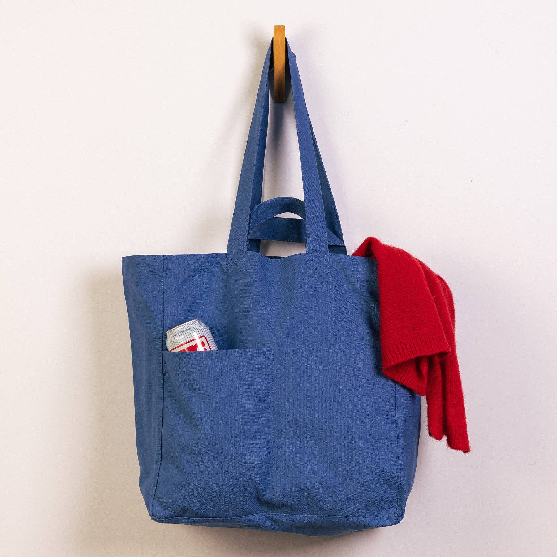 Blue tote bag with a pocket on a white background