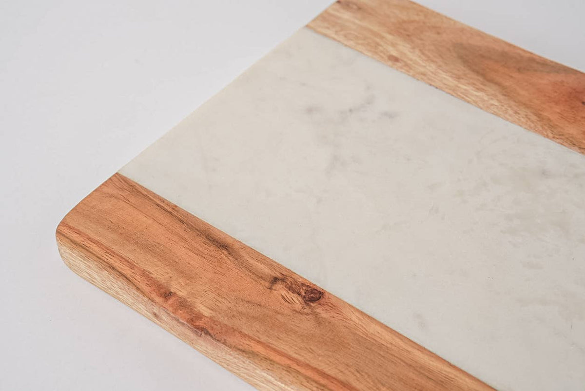 Wooden cutting board with a marble-like surface on a light gray background