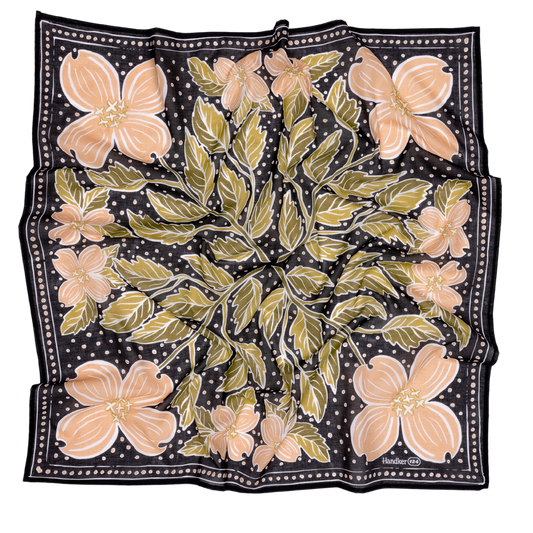 Floral patterned scarf with pink flowers and green leaves on a black background