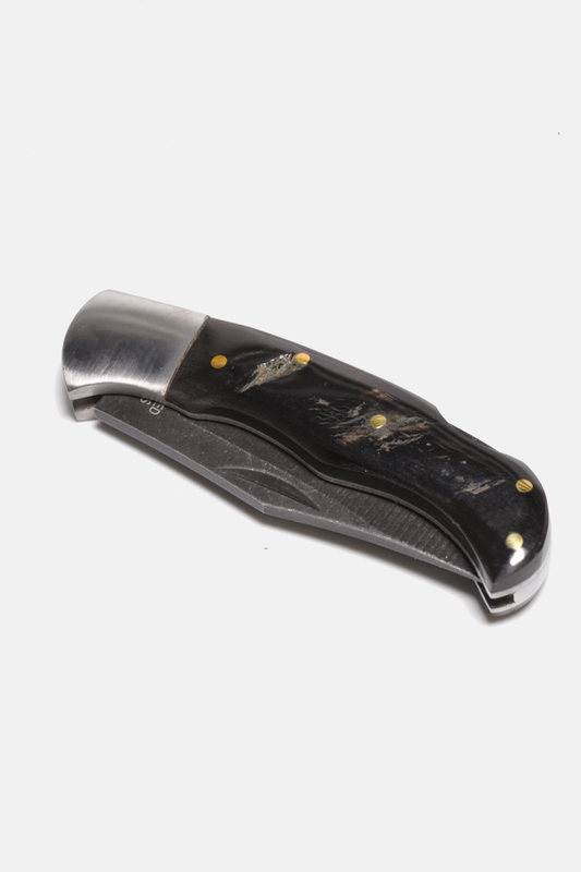 Foldable knife with black handle and silver blade on a white background