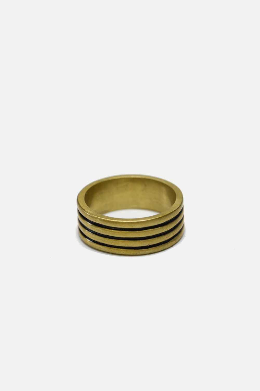Gold ring with four horizontal bands on a white background