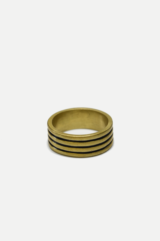 Gold ring with four horizontal bands on a white background