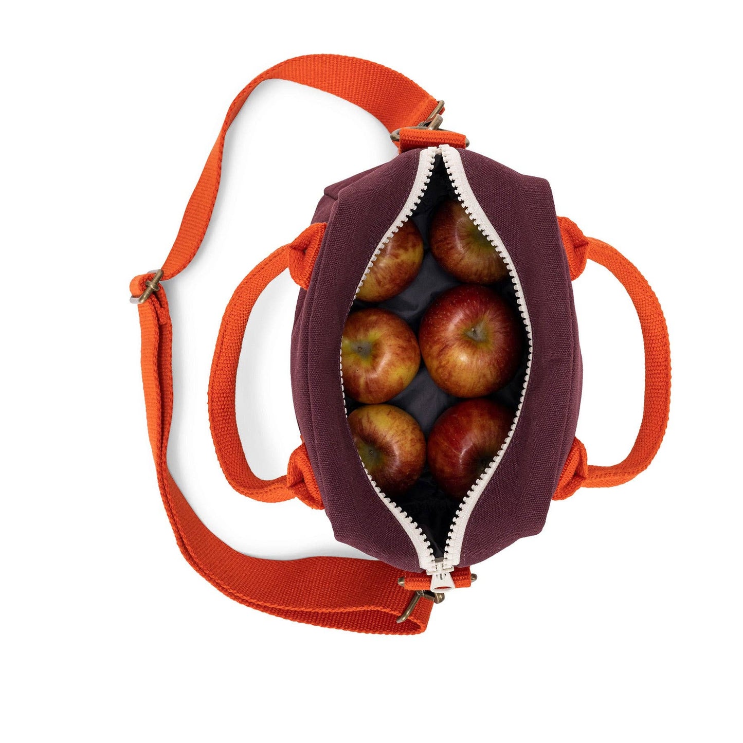 Small bag with orange strap filled with apples on a white background