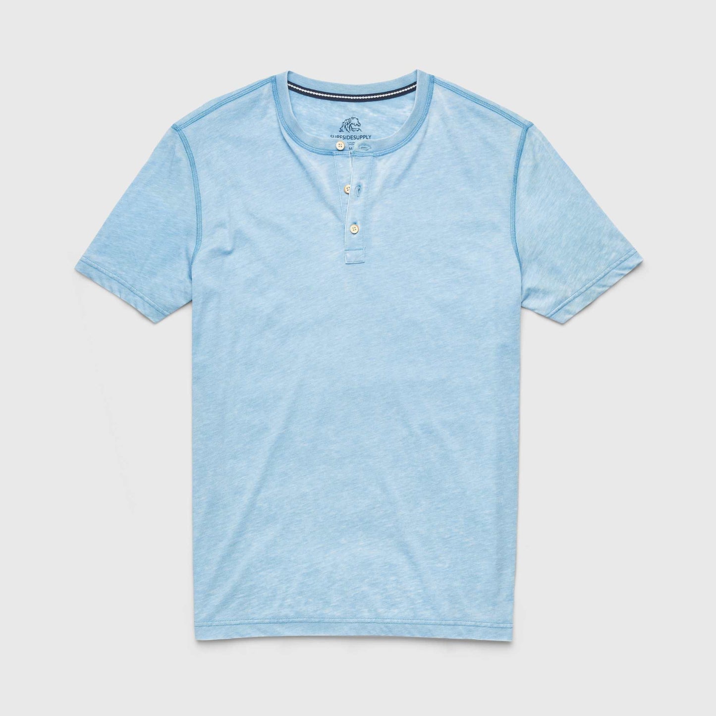 Light blue henley shirt on a light gray background