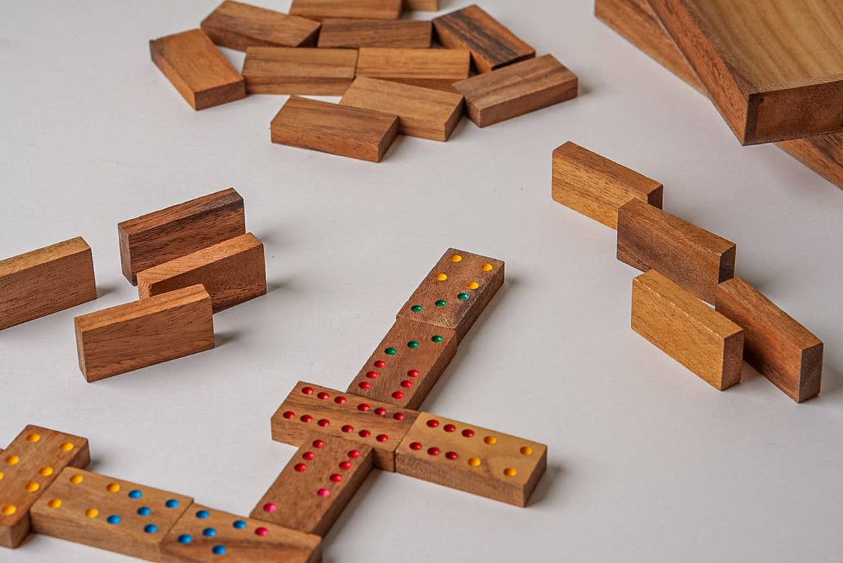 Wooden blocks with colored dots arranged on a light gray surface