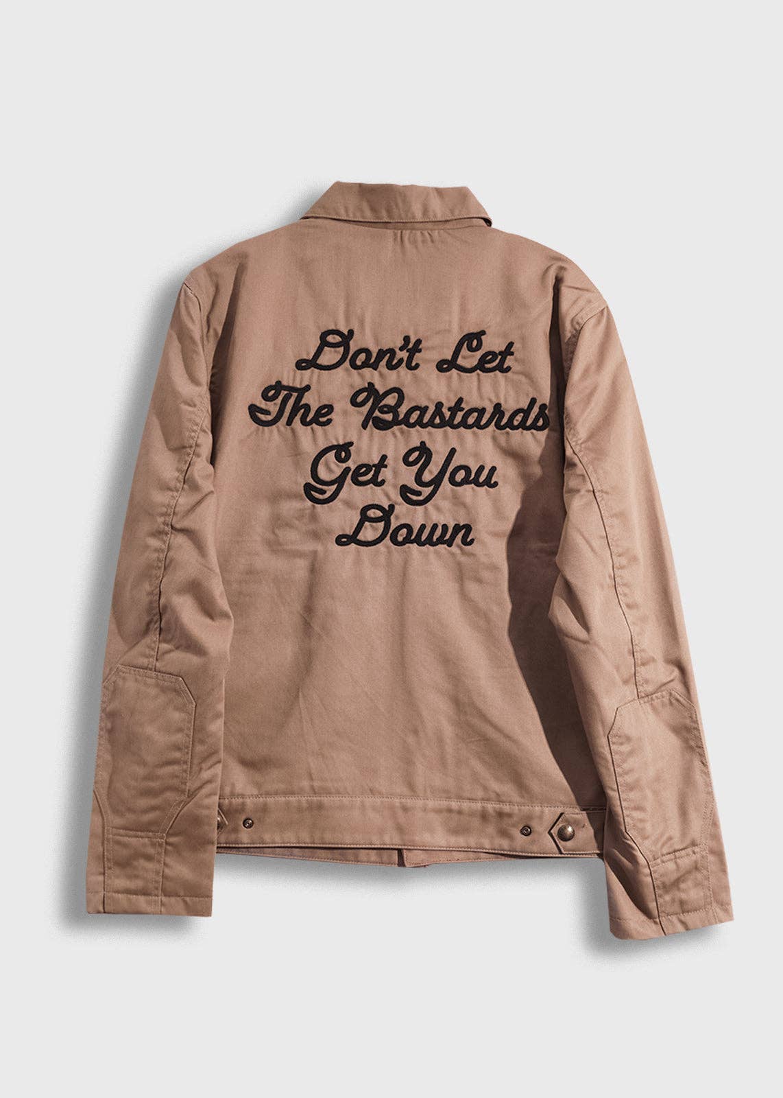 Tan jacket with text on the back against a light gray background
