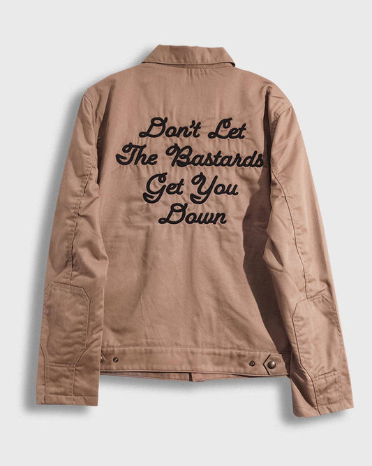 Tan jacket with text on the back against a light gray background